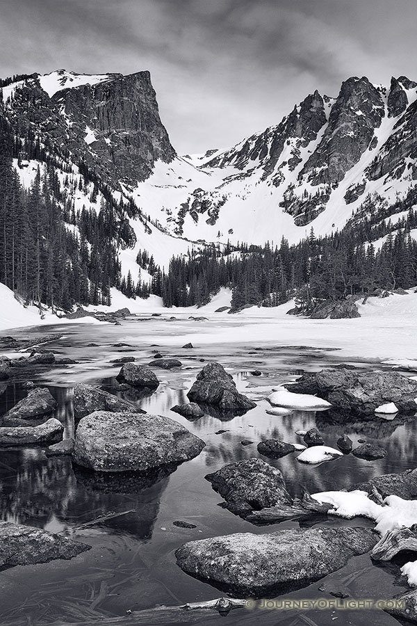 Snow and Ice still partially cover Dream Lake in Rocky Mountain National Park on a cold May morning. - Colorado Photography