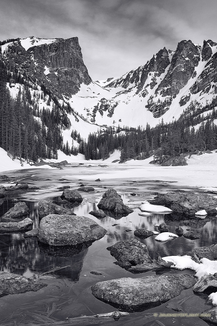 Snow and Ice still partially cover Dream Lake in Rocky Mountain National Park on a cold May morning. - Colorado Picture