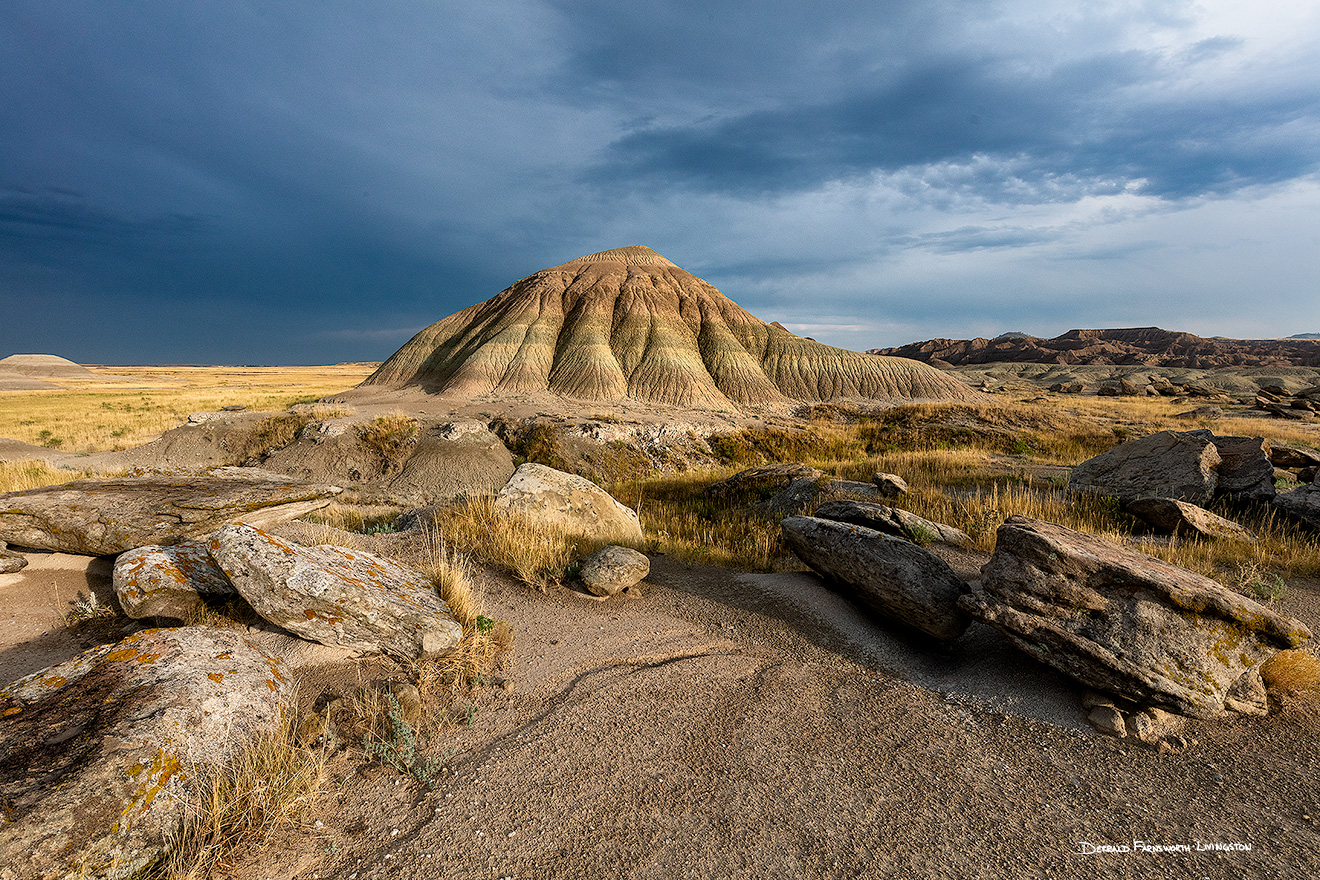 A scenic landscape photograph of Toadstool Geologic Park in western Nebraska under dark skies. - Nebraska Picture