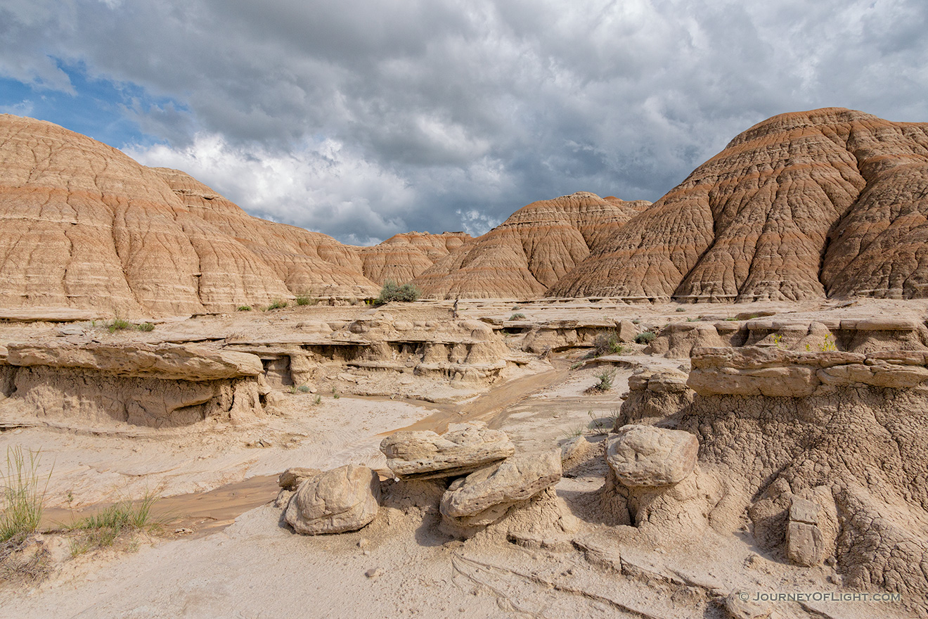 Afternoon clouds hover over the otherwordly landscape at Toadstool Geologic Park in Northwestern Nebraska. - Toadstool Geologic Park Picture