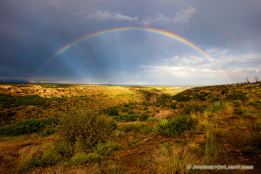 After an intense day of rain a beautiful rainbow appears over a canyon in the west area of Mesa Verde National Park. - Colorado Photography