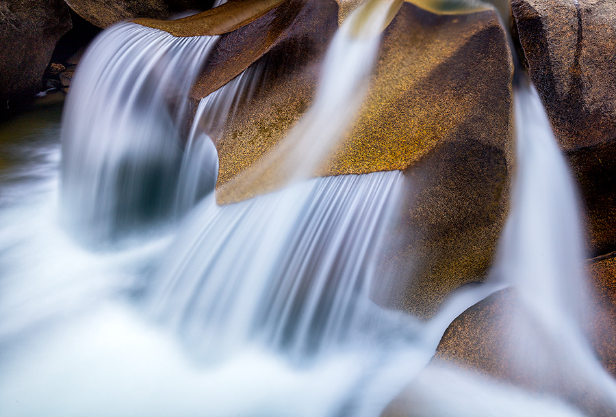 Water has smoothed the surface after thousands of years, constantly flowing across these rocks creating a unique pattern.  Grottos Waterfall in the White River National Forest in Colorado. - Colorado Photography