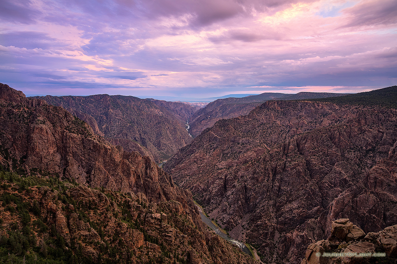 Pastel hues dominate the sky and are reflected throughout the canyon during a beautiful summer sunrise. - Colorado Picture