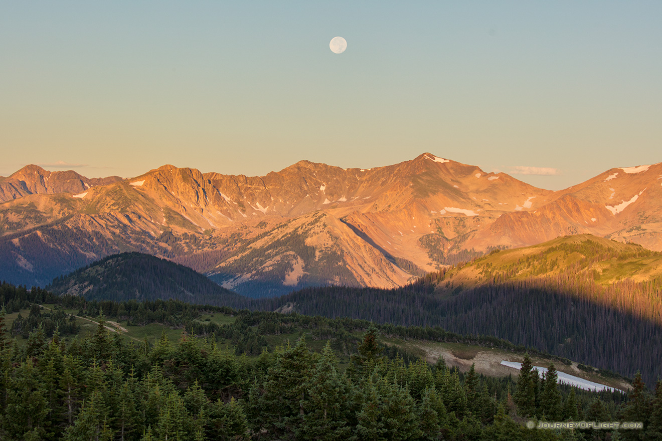 Landscape scenic photograph of the moon setting over the Never Summer Mountain Range, Rocky Mountain. - Colorado Picture