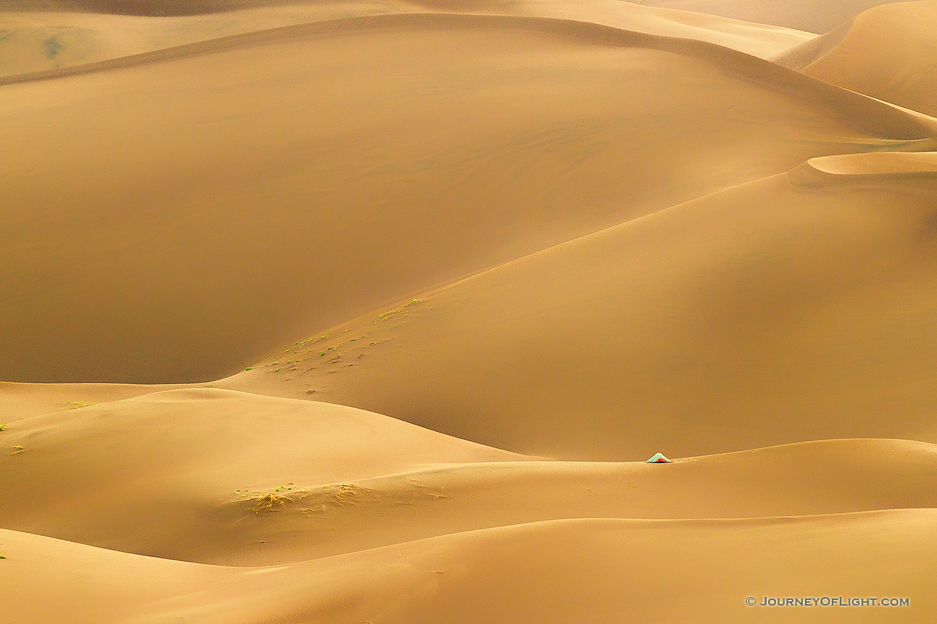 A tent stands on a distant dune in Great Sand Dunes National Park and Preserve in south central Colorado. - Colorado Picture