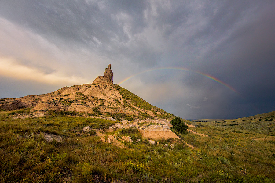 A scenic landscape Nebraska photograph of a rainbow over Chimney Rock in western Nebraska. - Nebraska Photography