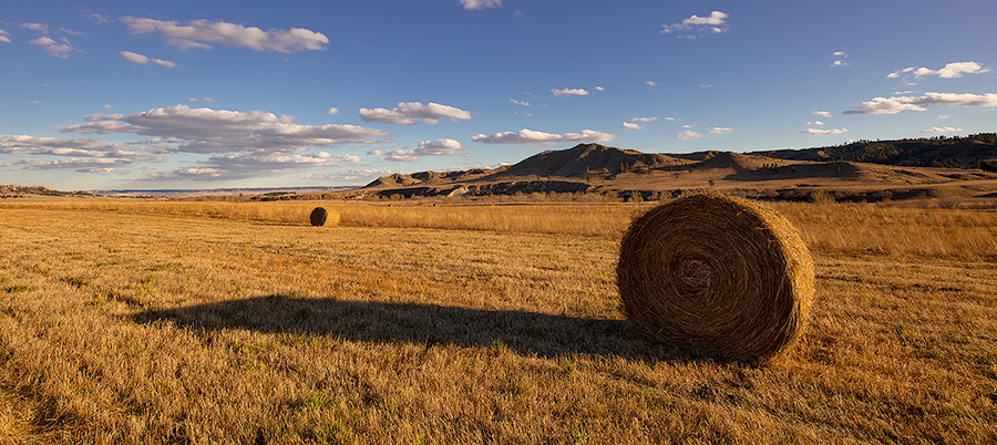 A scenic landscape pano photograph of hay bales at Ft. Robinson in Northwestern Nebraska. - Nebraska Photography