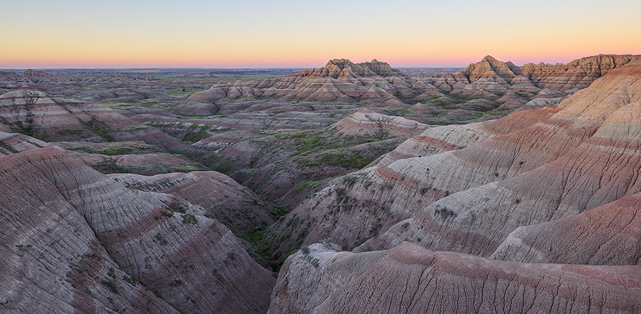 A panoramic scenic photograph of the sunrise over the Badlands National Park, South Dakota. - South Dakota Photography