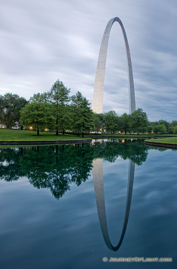 The Gateway Arch and its reflection at the Jefferson National Expansion Memorial in St. Louis, Missouri.  In 1980, Kenneth Swyers tried to parachute onto the Gateway Arch, he succeeded in reaching the structure, however, he failed in his subsequent base jump attempt, sliding down one side to his death.  - Jefferson National Expansion Memorial Photography