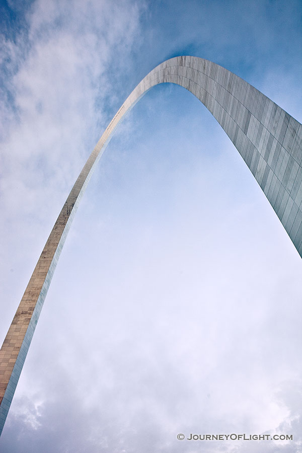 Built between February 12, 1963, and October 28, 1965 the Gateway Arch in St. Louis was designed to honor the westward expansion of the United States.  Designed by architect Eero Saarinen and engineer Hannskarl Bandel, it is 630 feet wide at its base and 630 feet tall and is currently the tallest monument in the United States.  From the base of the north leg looking in a south easterly directly, the structure curves through the sky almost touching the low clouds.  - Jefferson National Expansion Memorial Photography