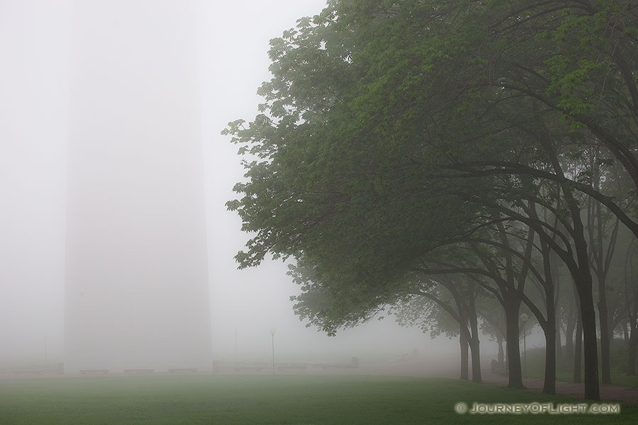 Through the thick fog the Gateway Arch in St. Louis is barely visible. - Jefferson National Expansion Memorial Photography