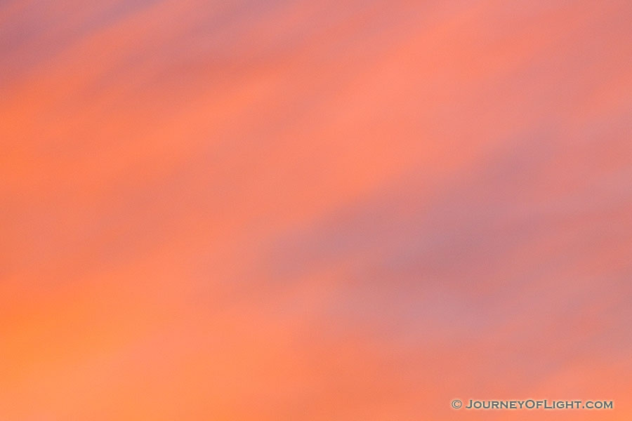 The setting sun illuminates these clouds with warm, inviting colors. - Nebraska Photography
