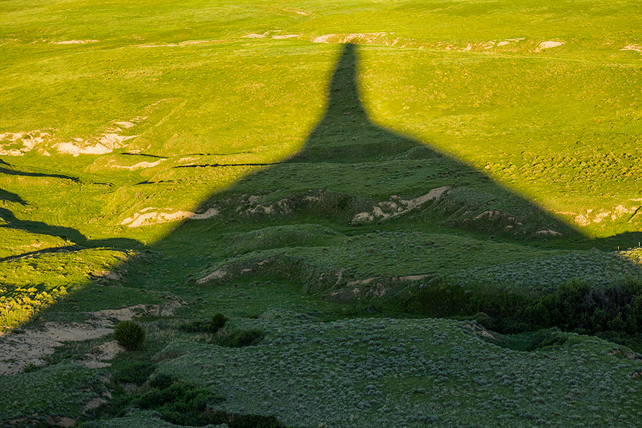 Chimney Rock's shadows stretches out across the plains as the sun dips low in the western sky. - Nebraska Photography