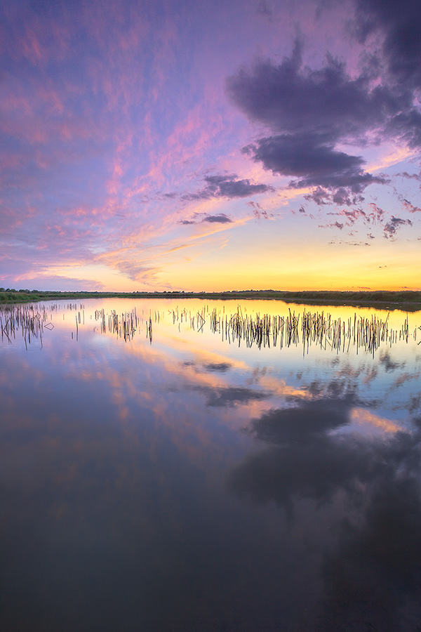 A scenic landscape photograph of a sunset reflected in the water at Jack Sinn WMA in eastern Nebraska. - Jack Sinn Photography