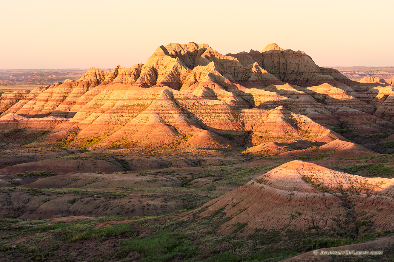 Light from the recently risen sun illuminates the Badlands in South Dakota with a warm orange hue. - South Dakota Picture
