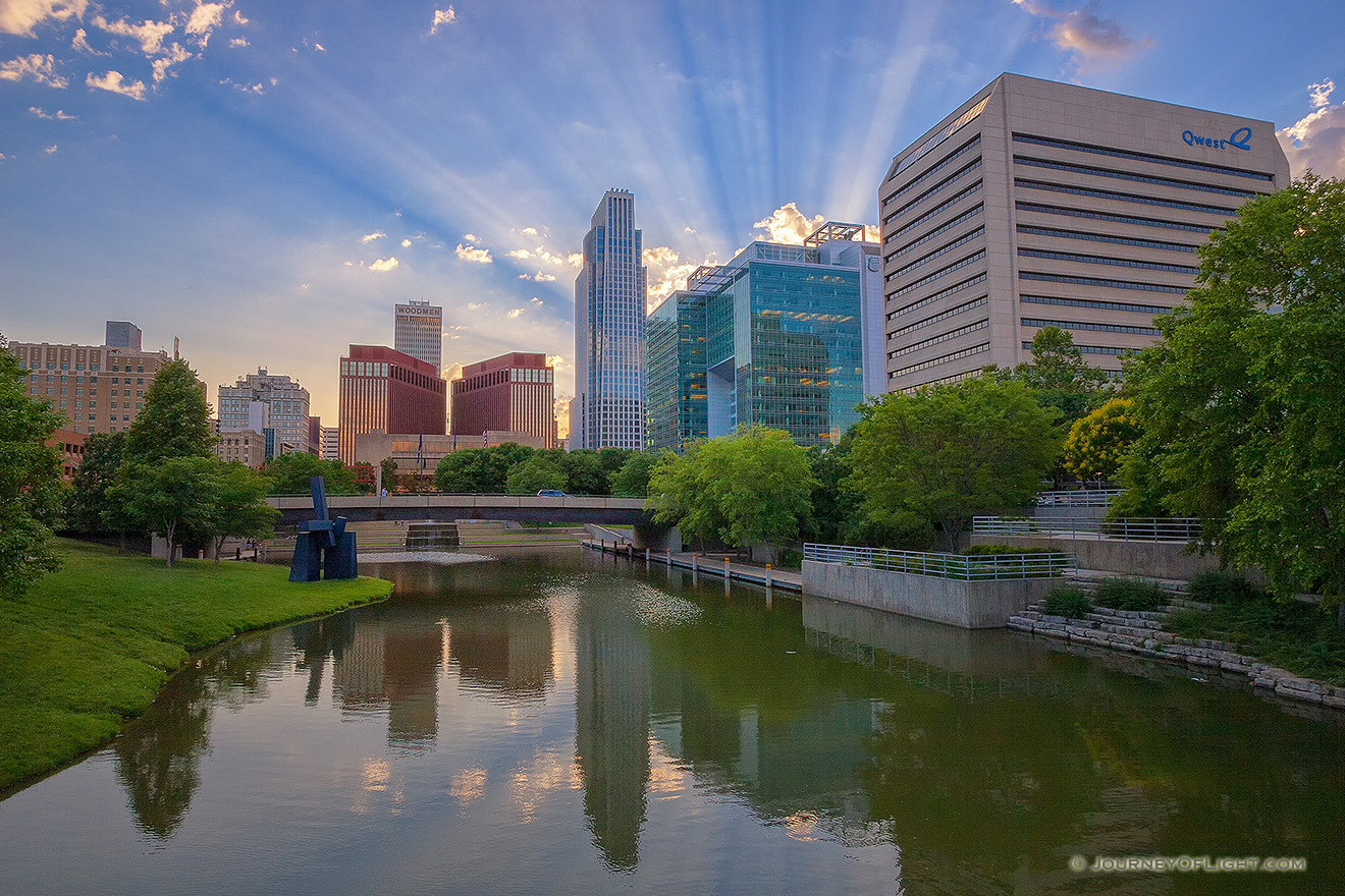 During a spring evening in Omaha, Nebraska I witnessed some spectacular godbeams.  This is the Gene Leahy Mall which runs down the center of downtown. - Omaha Picture