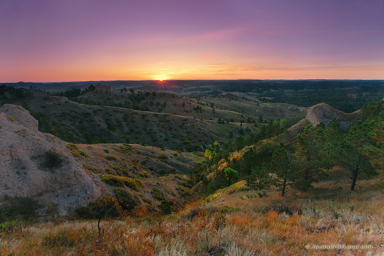On an early fall morning, the rising sun shines brightly across Chadron State Park, in western Nebraska. - Nebraska Picture