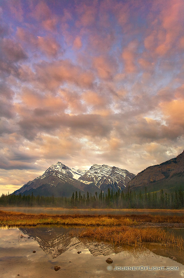The first light illuminates the clouds above mountains on the Kootenay plains in Alberta, Canada. - Canada Photography