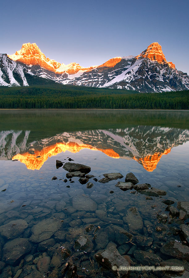 As the first light hits Mt. Cephron as mist rises from Upper Waterfowl Lake. - Banff Photography