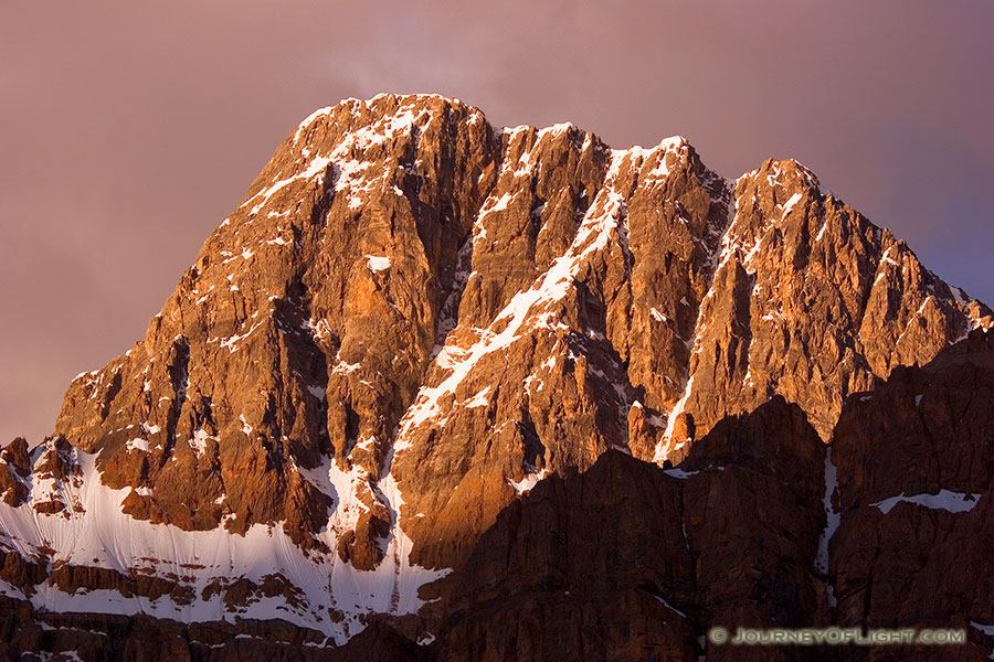 The peaks of the Bow Range with an intense glow from the rising sun. - Banff Photography