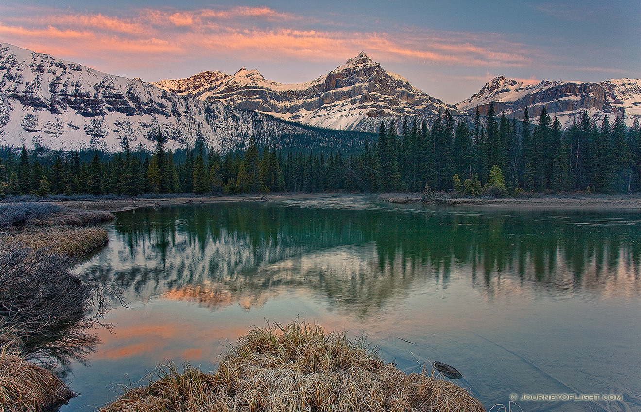 The morning sun hits the Mt. Lauriet near an Oxbow of the Mistaya River in Banff National Park. - Banff Picture