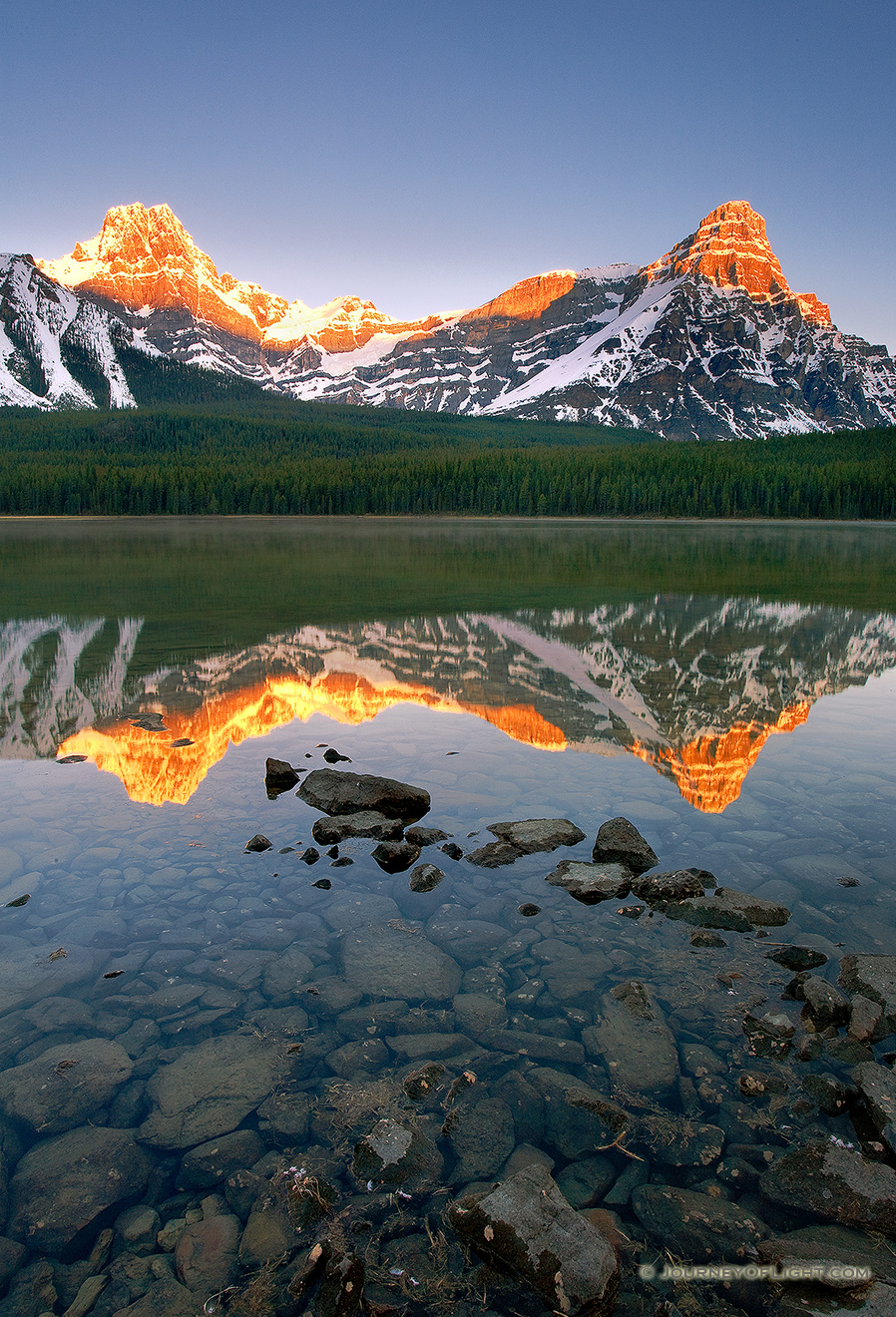 As the first light hits Mt. Cephron as mist rises from Upper Waterfowl Lake. - Banff Picture