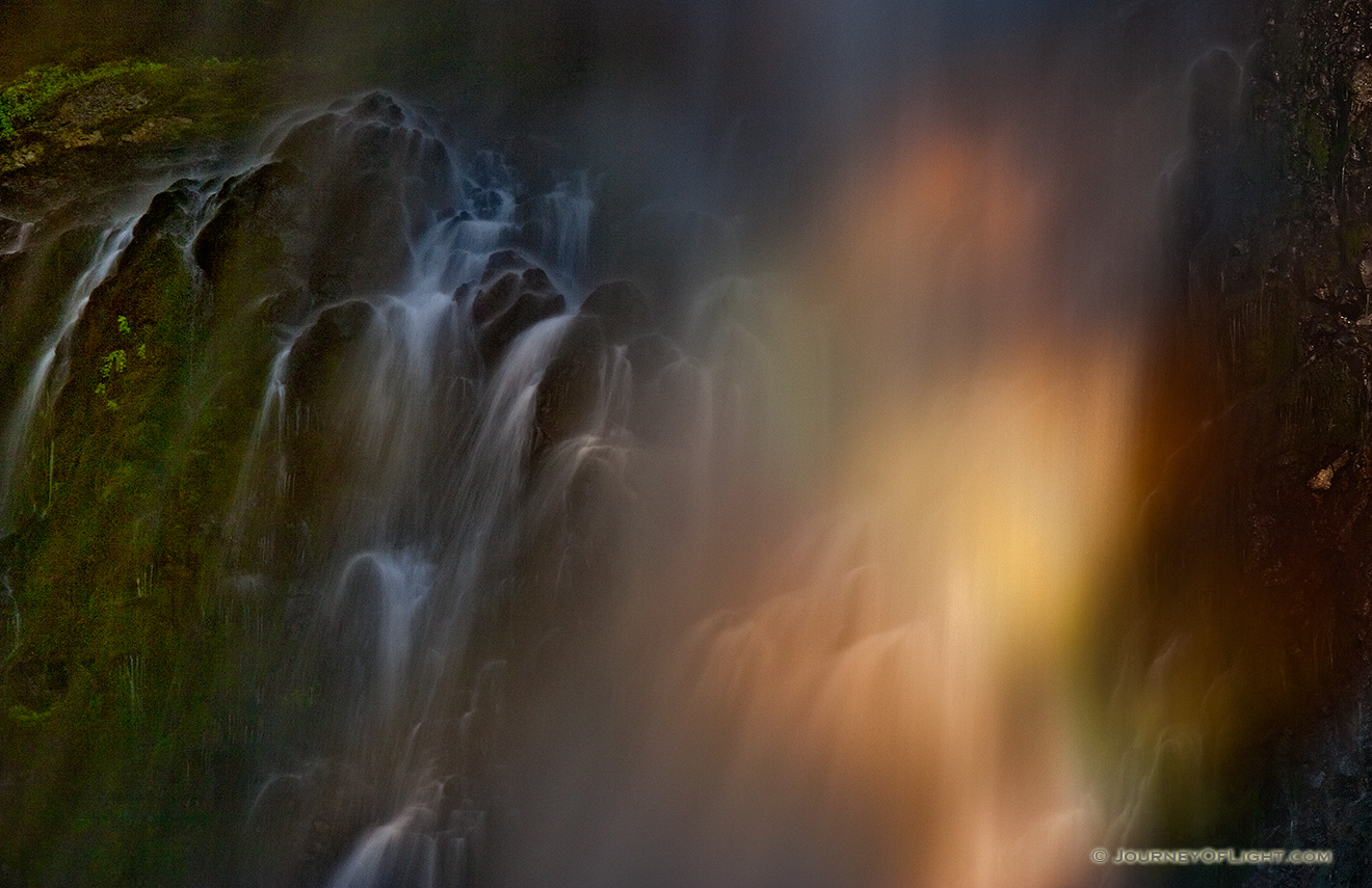 Focused on a small section of Multnomah Falls where the setting sun illuminated a small area creating a rainbow in the mist. - Pacific Northwest Picture